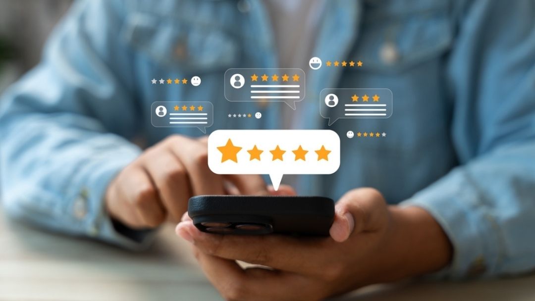 Business professional viewing customer star ratings and reviews on smartphone with five-star feedback overlays for reputation management