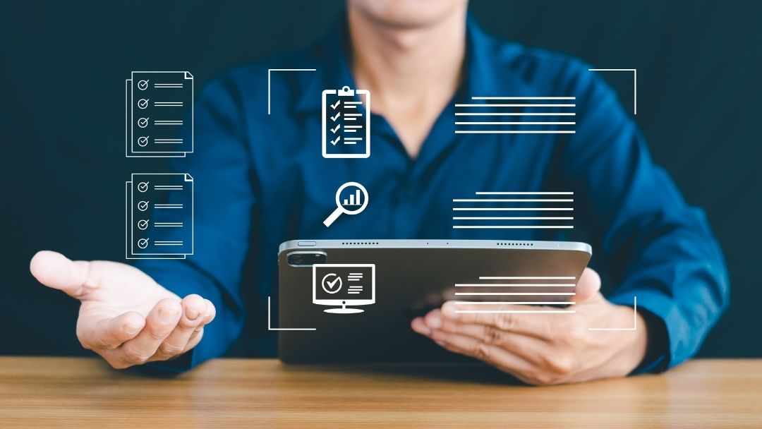 Person holding tablet with holographic icons of checklists, surveys, and data analysis, representing research tools.