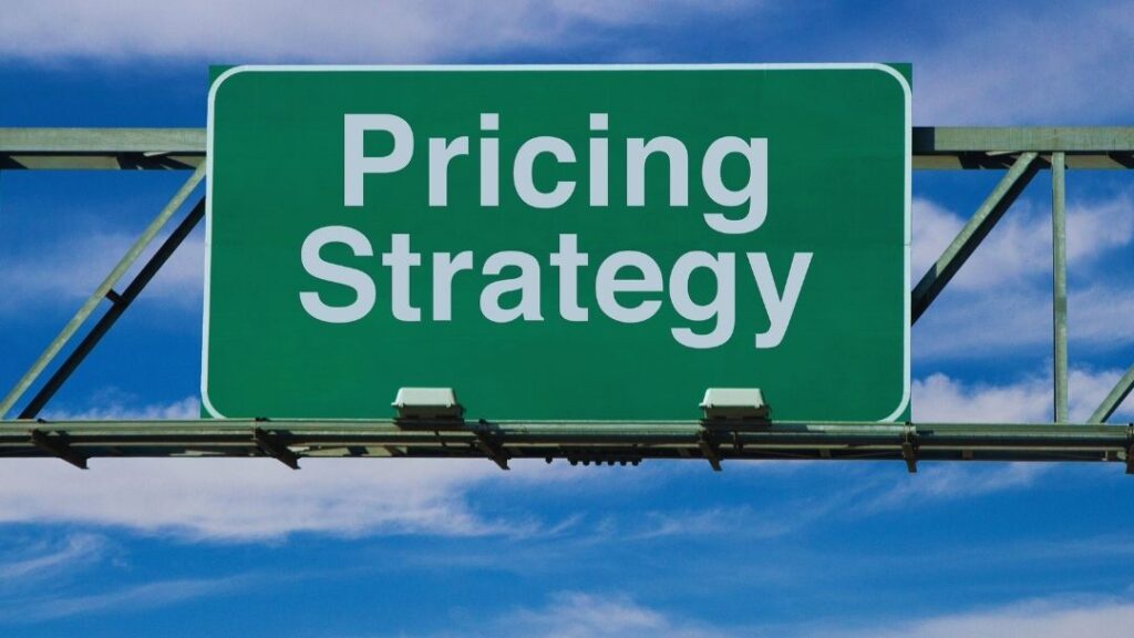 Green highway sign reading "Pricing Strategy" against a blue sky with clouds, data-driven price testing.